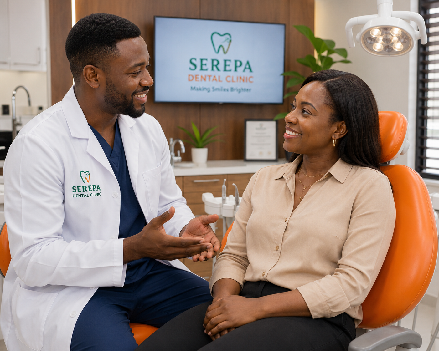 A smiling young professional sitting comfortably in a dental chair while a dentist explains treatment to her