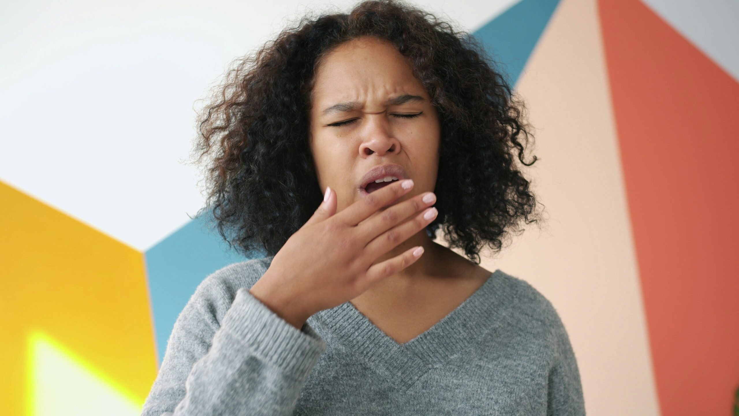 A woman yawning to test her breath